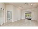 Bright living room featuring tile flooring, neutral walls and sliding doors leading to the pool area at 170 Greenhaven Cir, Oldsmar, FL 34677