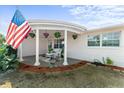 Covered porch with hanging plants and seating area at 2333 Tahitian Dr, Holiday, FL 34691