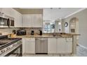 Bright kitchen features stainless appliances, granite countertops, and white cabinetry at 2722 Via Tivoli # 432B, Clearwater, FL 33764