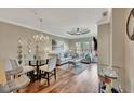 Open-concept living room and dining area with hardwood floors and elegant chandelier at 2722 Via Tivoli # 432B, Clearwater, FL 33764