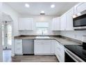 Modern kitchen with white shaker cabinets, stainless steel appliances, and granite countertops at 4720 Grace N St, St Petersburg, FL 33714