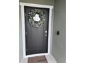 Modern front door with stylish wreath and keyless entry at 493 Omen St, Punta Gorda, FL 33982
