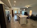 Open kitchen with island, stainless steel appliances, and breakfast bar at 493 Omen St, Punta Gorda, FL 33982