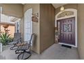 Inviting front porch with seating for two and charming decor at 5225 Algerine Pl, Wesley Chapel, FL 33544