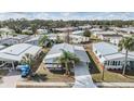 Overhead view of a well-situated property in a peaceful community, showcasing its metal roof and convenient carport at 5539 Regal Way, Zephyrhills, FL 33541