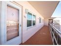Building hallway with light-colored walls and flooring, featuring a unit entrance at 5623 80Th N St # 505, St Petersburg, FL 33709