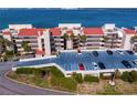 Exterior showcasing the parking, lush landscaping, and beautiful multi-story condominium building at 5633 Puerta Del Sol S Blvd # 306, St Petersburg, FL 33715