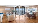 Bright living room with water views, stylish furniture, and dining area at 5633 Puerta Del Sol S Blvd # 306, St Petersburg, FL 33715