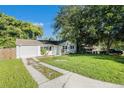 Newly renovated house with a long driveway at 7202 N 21St St, Tampa, FL 33610