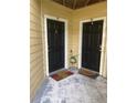Two condo unit entry doors with welcome mats at 8615 Mallard Reserve Dr # 102, Tampa, FL 33614