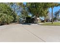 House with spacious paved driveway and surrounding trees at 931 And 925 Florida Ave, Palm Harbor, FL 34683