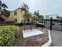 Condo building with a gated entrance and seating area at 107 S Obrien St # 220, Tampa, FL 33609