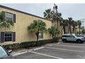 Condo building exterior showcasing parking and landscaping at 107 S Obrien St # 220, Tampa, FL 33609