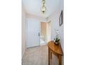 Inviting entryway featuring neutral tones, tile flooring, and decorative lighting at 113 Lindsay Ln # 23, Oldsmar, FL 34677