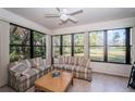 Bright sun room with large windows offering views of the green landscape and golf course at 113 Lindsay Ln # 23, Oldsmar, FL 34677