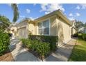 Side view of a lovely villa showcasing a walkway and well-maintained landscaping at 11575 Captiva Kay Dr, Riverview, FL 33569