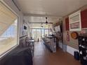 Entertaining bar area complete with seating, bar, ceiling fans, and a view through the windows at 117 S Saint Thomas Cir, Apollo Beach, FL 33572