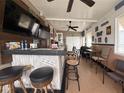 Entertaining bar area featuring a custom bar, stools, multiple TVs, and seating at 117 S Saint Thomas Cir, Apollo Beach, FL 33572