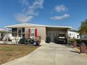 Inviting exterior showing a single story home, golf cart, and well-maintained landscaping at 117 S Saint Thomas Cir, Apollo Beach, FL 33572