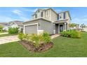 Two-story house with gray siding, brick pavers, and landscaping at 11868 Little River Way, Parrish, FL 34219