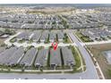 Aerial view of a residential community showcasing the layout and surrounding landscape with lake at 12099 Gavin Ln, Odessa, FL 33556