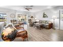 Relaxing living room featuring wicker furniture and patio access at 141 Glendower Cir # 250, Sun City Center, FL 33573