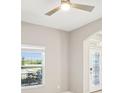Bright living room featuring natural light, neutral paint, archways, and an ornate front door at 18863 Roseate Dr, Lutz, FL 33558