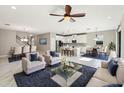 Spacious open-concept living area with modern furnishings, dining area, and a white kitchen at 18863 Roseate Dr, Lutz, FL 33558