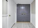 Elegant front door with decorative details and polished hardware, situated in a hallway at 220 Belleview Blvd # 108, Belleair, FL 33756