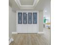 Stylish hallway closet with decorative glass doors, enhancing the entryway at 220 Belleview Blvd # 108, Belleair, FL 33756