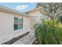 Inviting front entrance with decorative door, lush landscaping, and a well-maintained walkway at 2333 Brookfield Greens Cir, Sun City Center, FL 33573