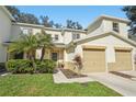 Inviting townhome with a well-maintained lawn, mature palm trees, and attached two-car garage at 2938 Royal Tuscan Ln, Valrico, FL 33594