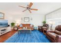 Inviting living area boasting hardwood floors, a comfortable sofa, and a large screen TV for entertainment, creating a relaxing ambiance at 301 Andover S Pl # 185, Sun City Center, FL 33573
