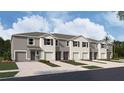 New townhome community with attached garages and landscaping at 31277 Midnight Sun Way, Wesley Chapel, FL 33545