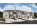 New townhome community with attached garages and landscaping at 31279 Midnight Sun Way, Wesley Chapel, FL 33545