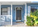 Dark brown front door with a stained glass window and white trim at 345 Dr Ml King Jr N St, Safety Harbor, FL 34695