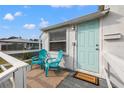 House exterior with teal front door and small deck at 3645 5Th S Ave, St Petersburg, FL 33711