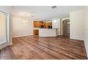 Spacious living room with open floor plan and wood-look flooring throughout at 3900 Claybrook Dr, Wesley Chapel, FL 33544