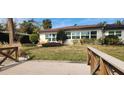 Backyard view of a waterfront home with a wooden footbridge at 5253 Dover Ne St, St Petersburg, FL 33703