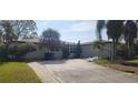 House exterior with a large yard and palm trees at 5253 Dover Ne St, St Petersburg, FL 33703