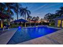 Sparkling in-ground pool with ample seating areas and manicured landscaping offering a serene outdoor oasis at 633 Poinsettia Rd, Belleair, FL 33756