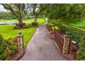 Long, gated driveway with decorative stone pillars leading to this estate at 1007 Lakewood Dr, Brandon, FL 33510