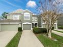 Front view of two story townhome with double garage at 10120 Post Harvest Dr, Riverview, FL 33578