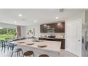 Modern kitchen with an island, stainless steel appliances, and white countertops at 10596 Farm Hill Ave, Land O Lakes, FL 34638