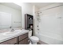 Clean bathroom with shower/tub combo and dark brown vanity at 11976 Brighton Knoll Loop, Riverview, FL 33579