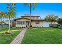 House exterior featuring a brick walkway and palm trees at 156 29Th N Ave, St Petersburg, FL 33704