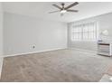 A bright and airy living room with a large window and neutral colored carpet at 1901 Andover Way # 32, Sun City Center, FL 33573