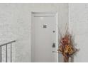 Apartment door with unit number and a decorative floral arrangement alongside at 205 S Mcmullen Booth Rd # 202, Clearwater, FL 33759