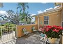 Outdoor patio features a decorative wall, paver flooring, potted plants, and comfortable seating at 2471 Kensington Greens Dr, Sun City Center, FL 33573