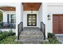 Welcoming front entrance with a stylish black multi-pane front door and brick-paved steps at 2810 W Alline Ave, Tampa, FL 33611